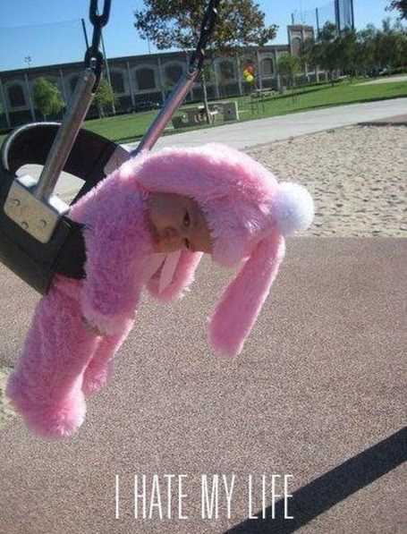 LittleKidInABunnyCostumeOnASwing