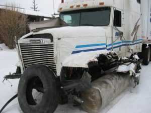 Truck With Winter Tire Truck Missing Wheel, But With Tire In Front Of Hood