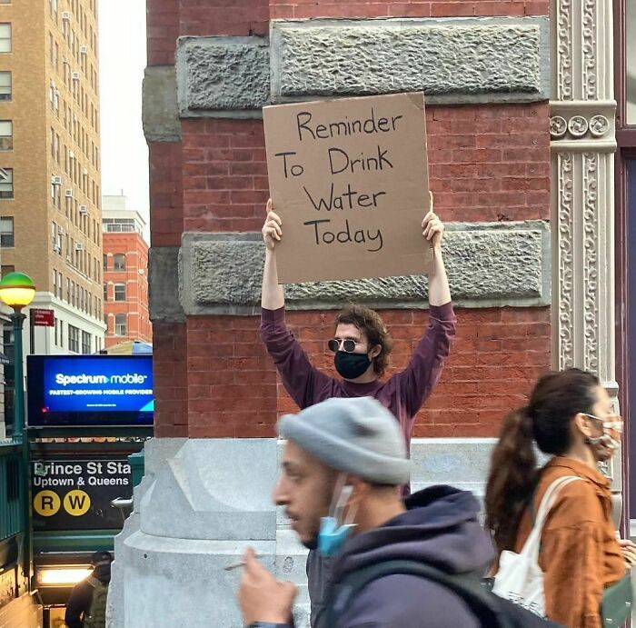 30 Hilarious Pictures Of A Man Protesting Obscure Things