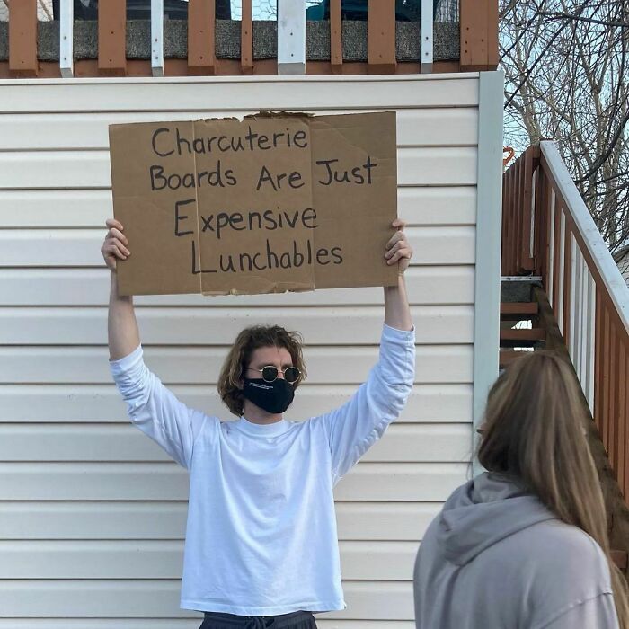 30 Hilarious Pictures Of A Man Protesting Obscure Things