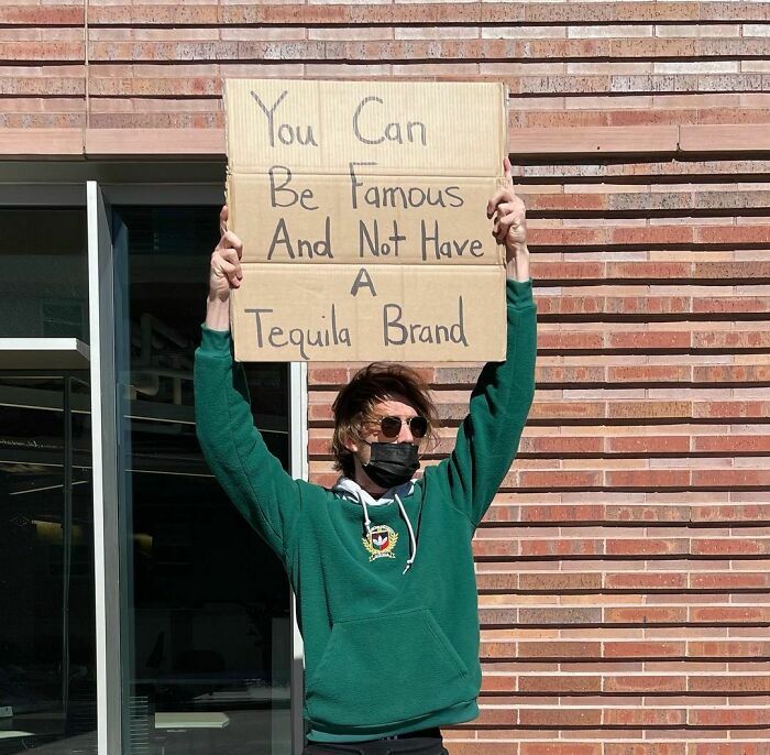 30 Hilarious Pictures Of A Man Protesting Obscure Things