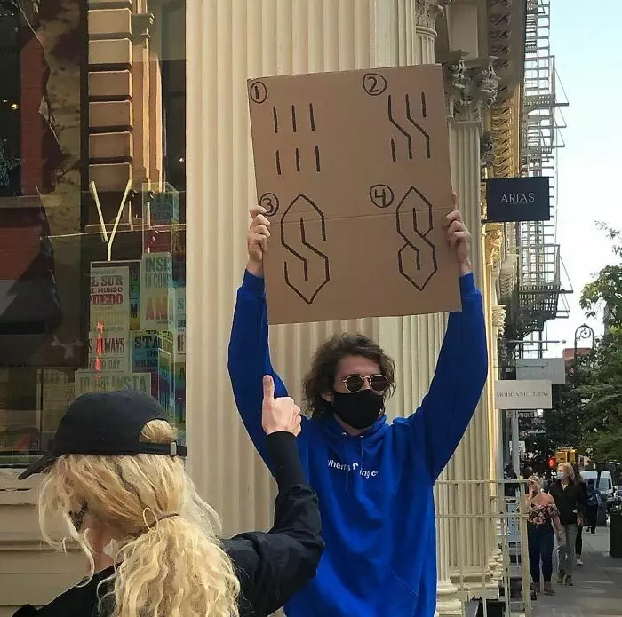 30 Hilarious Pictures Of A Man Protesting Obscure Things