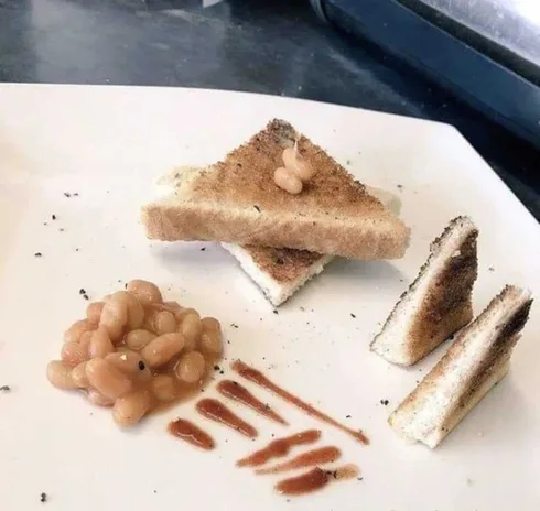 Cooking-After-Masterchef Meme Featuring A Plate Of Toast And Baked Beans Arranged Artistically After Watching Masterchef